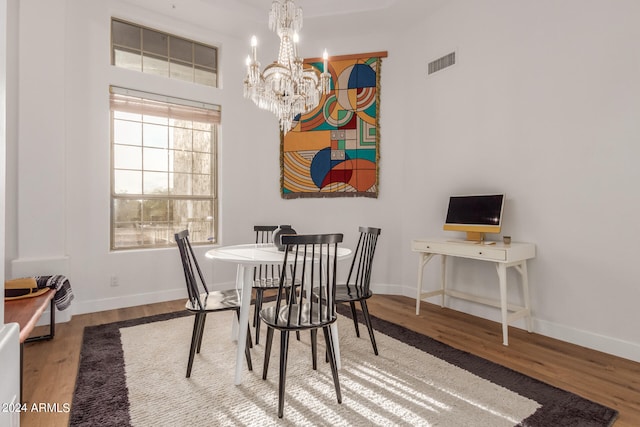 dining space featuring an inviting chandelier and wood-type flooring