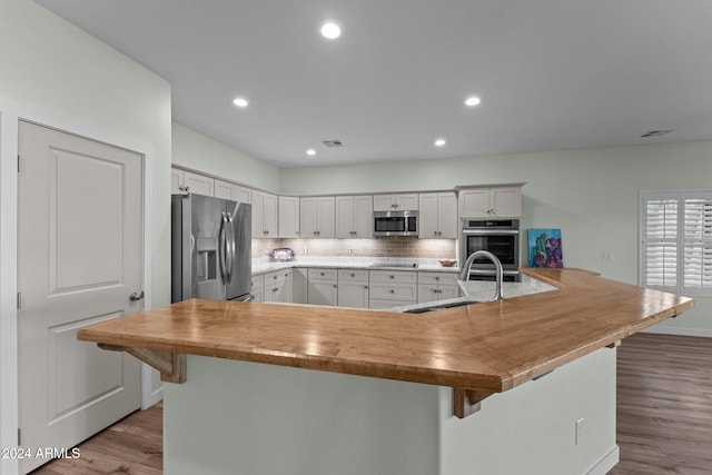 kitchen featuring white cabinetry, light hardwood / wood-style floors, stainless steel appliances, and sink