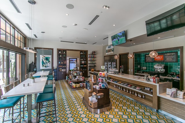 bar featuring decorative light fixtures and recessed lighting