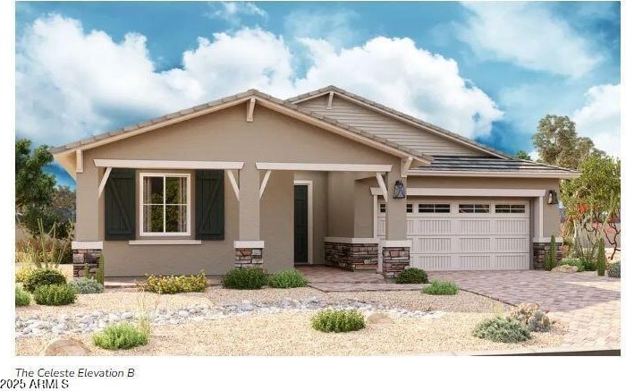 view of front of property with stucco siding, an attached garage, stone siding, and decorative driveway