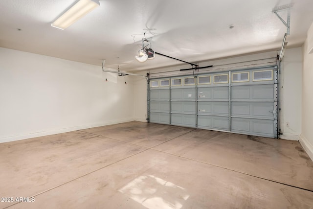 2402 E 5th St Unit 1411, Tempe, AZ 85288 - garage featuring a garage door opener and baseboards