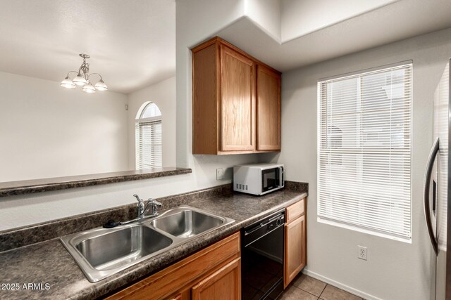 2402 E 5th St Unit 1411, Tempe, AZ 85288 - kitchen with white microwave, black dishwasher, dark countertops, a sink, and light tile patterned floors