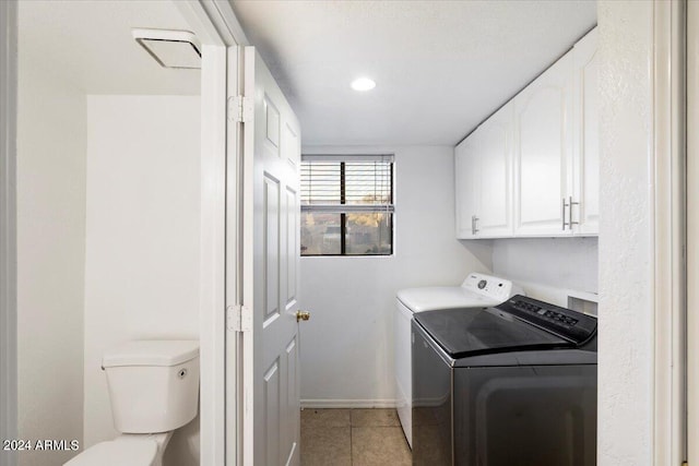 laundry area with cabinets, light tile patterned floors, and independent washer and dryer