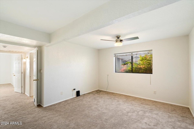 spare room with light colored carpet and ceiling fan