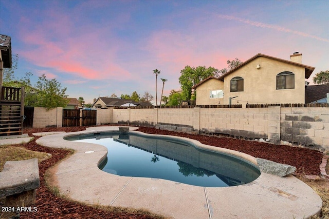 view of pool at dusk