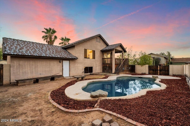 view of pool at dusk