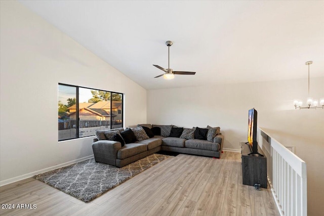 living room with wood-type flooring, high vaulted ceiling, and ceiling fan with notable chandelier