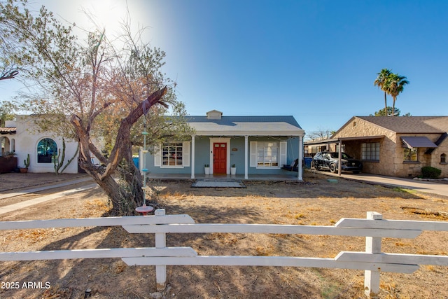 view of front of home featuring a fenced front yard and covered porch