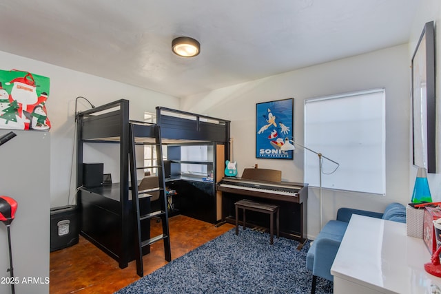 bedroom with refrigerator and concrete floors