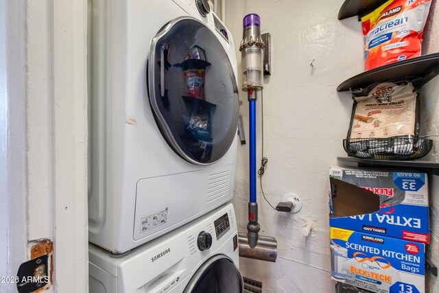 washroom with laundry area and stacked washer / dryer