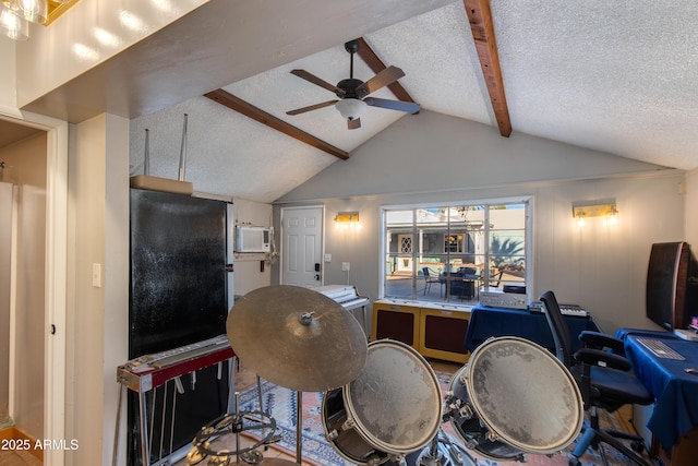 interior space featuring lofted ceiling with beams, a textured ceiling, ceiling fan, and freestanding refrigerator