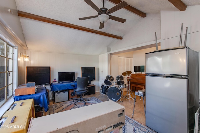 office space featuring tile patterned flooring, a textured ceiling, lofted ceiling with beams, and a ceiling fan