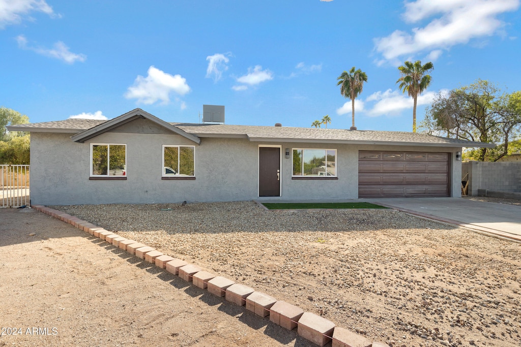 ranch-style home featuring a garage