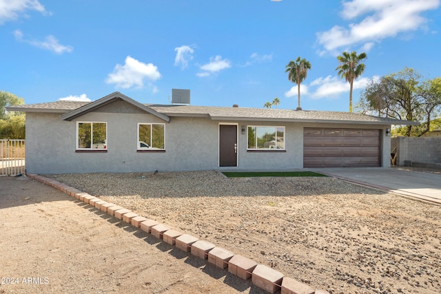 ranch-style home featuring a garage