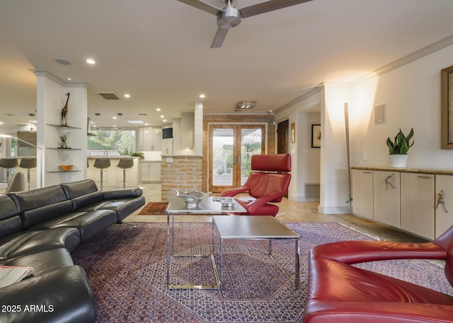 living room featuring ceiling fan, french doors, and crown molding