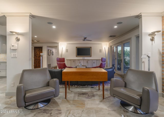 interior space with ceiling fan and ornamental molding