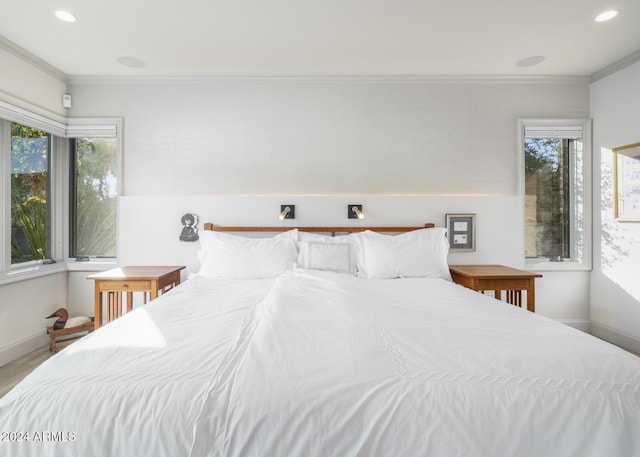 bedroom featuring hardwood / wood-style floors and crown molding