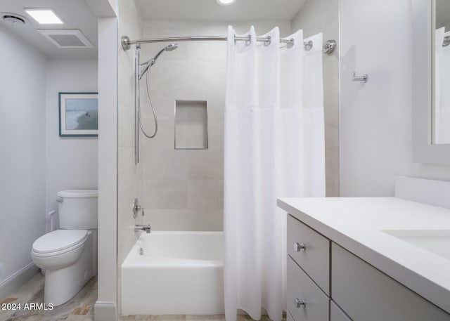 full bathroom with vanity, shower / tub combo, and toilet