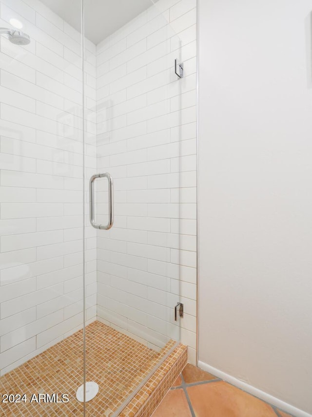 bathroom with tile patterned flooring and an enclosed shower