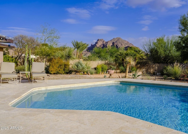 view of pool featuring a mountain view and a patio area