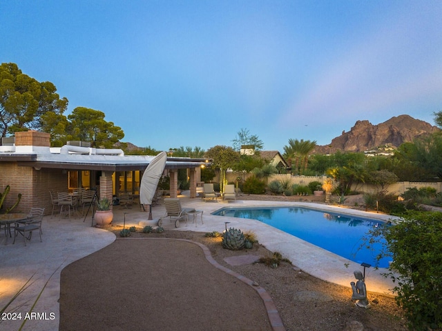 view of pool with a mountain view and a patio