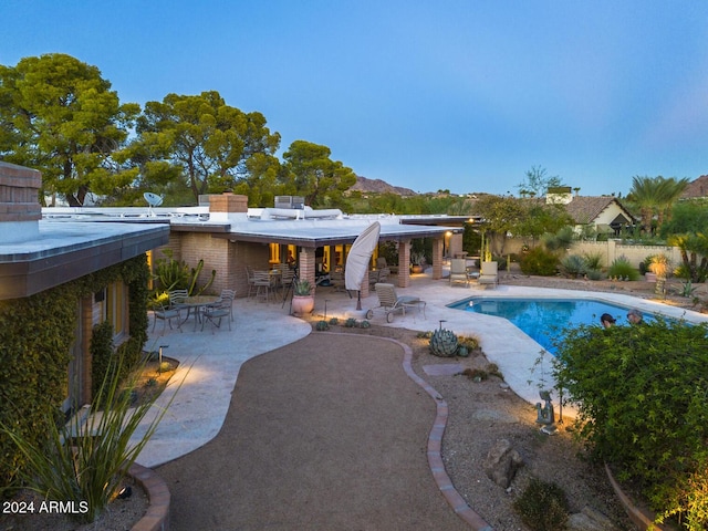 view of swimming pool featuring a mountain view and a patio