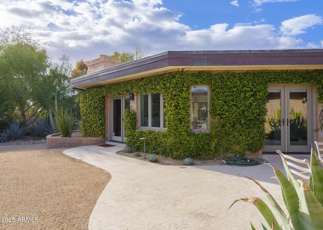 view of front of house with french doors and a patio