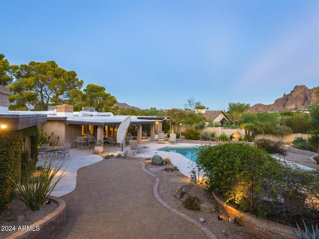 view of swimming pool with a mountain view and a patio