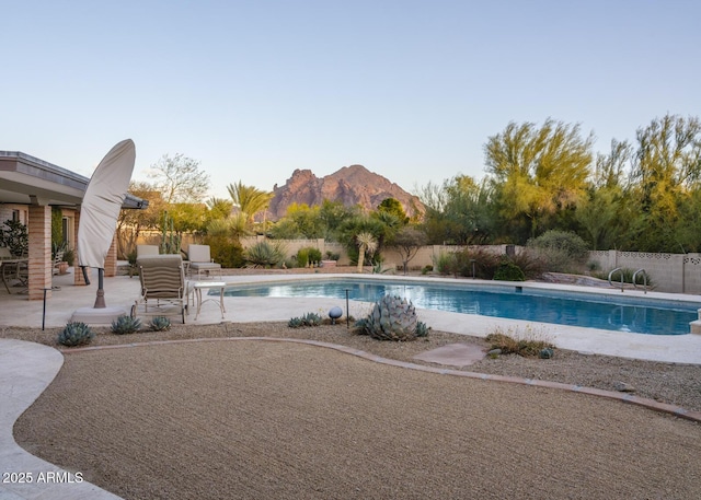 view of swimming pool featuring a mountain view and a patio area