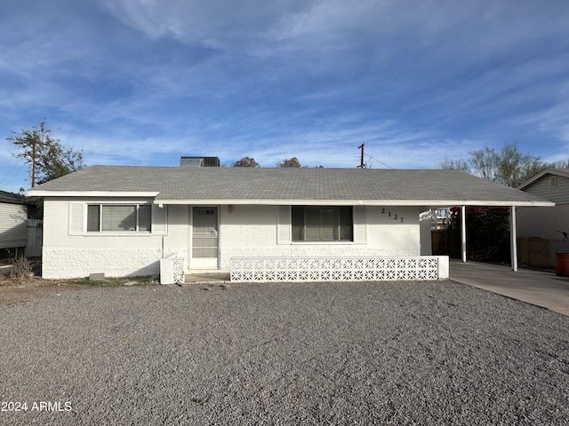 ranch-style house featuring a carport