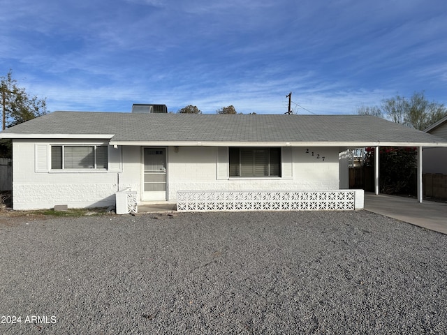 ranch-style house featuring a carport