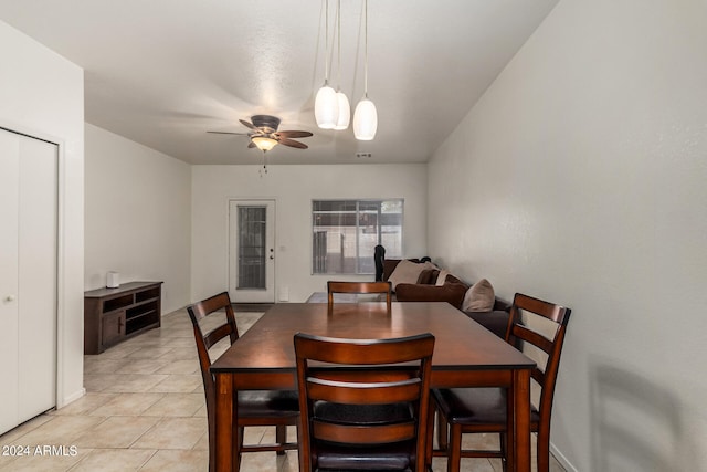 tiled dining area with ceiling fan