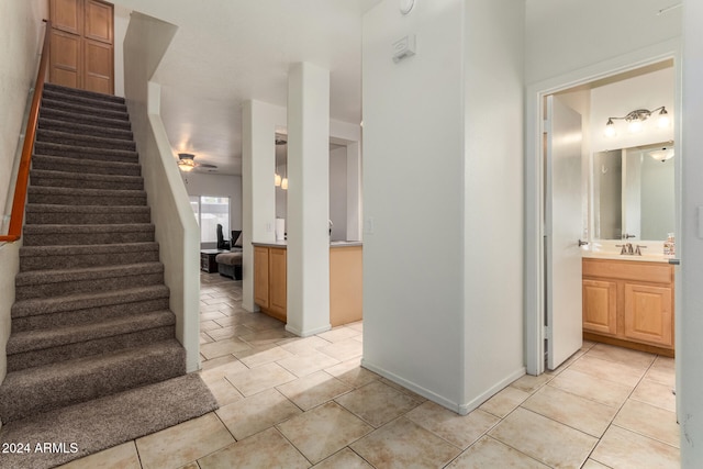 interior space with tile patterned flooring, sink, and ceiling fan