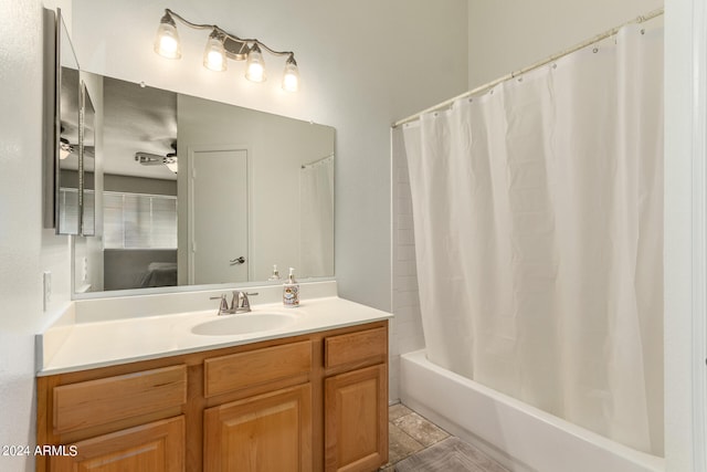 bathroom featuring shower / tub combo with curtain, vanity, and ceiling fan