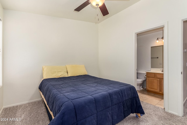 bedroom featuring ceiling fan, light carpet, and ensuite bathroom