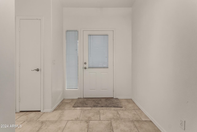 entryway with light tile patterned flooring