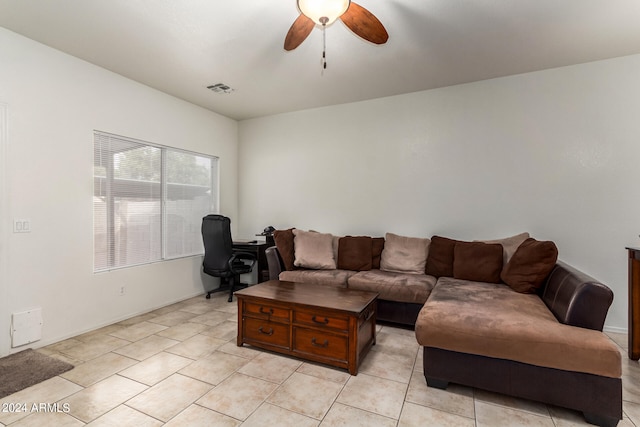 tiled living room with ceiling fan