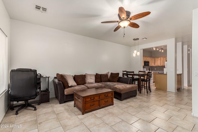 living room featuring ceiling fan with notable chandelier