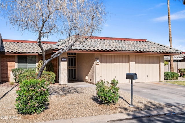 view of front facade with a tiled roof and stucco siding