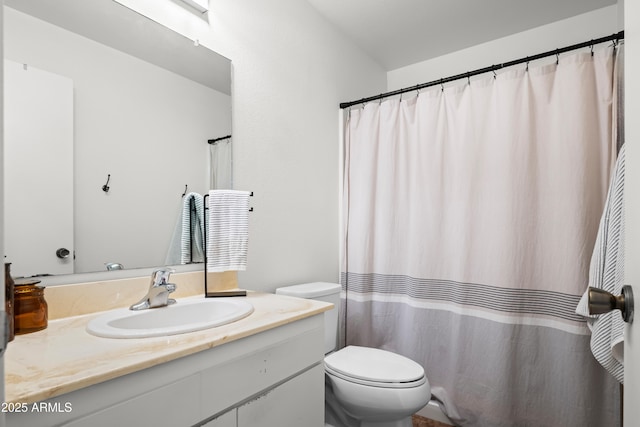 bathroom featuring toilet and vanity