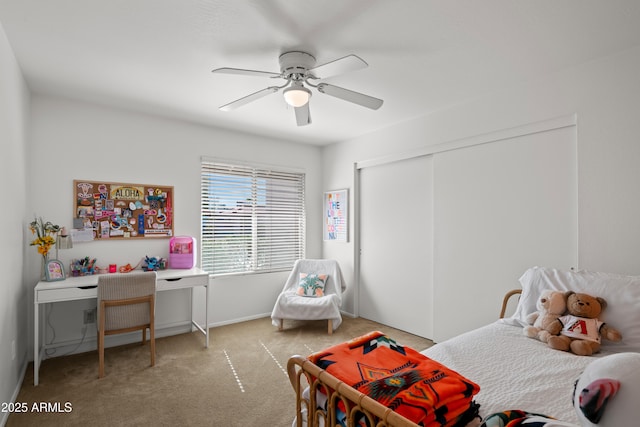 carpeted bedroom with a closet and ceiling fan