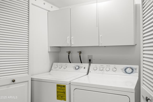 washroom featuring cabinet space and separate washer and dryer