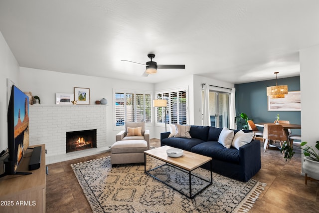 living room with a brick fireplace and a ceiling fan