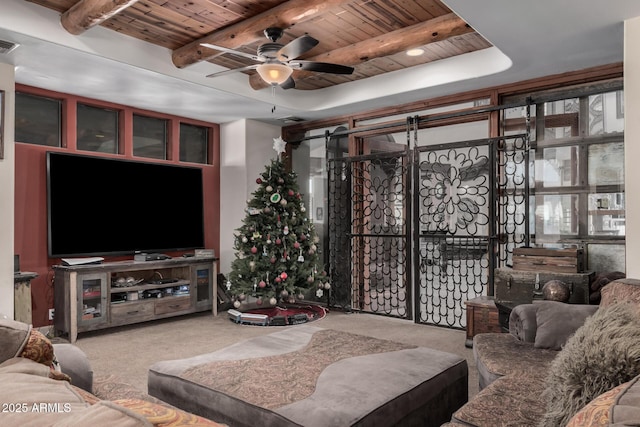 carpeted living room with beam ceiling, ceiling fan, and wood ceiling