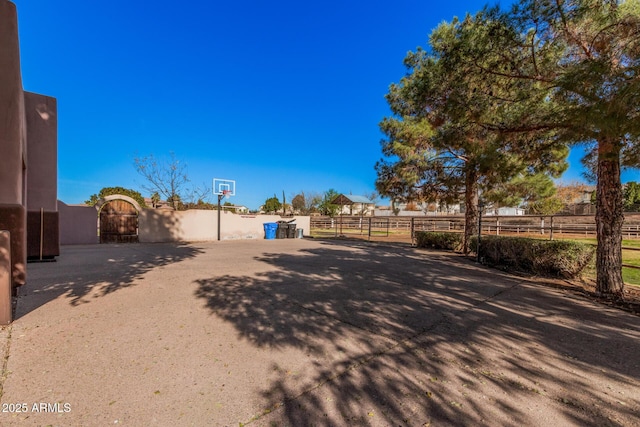 view of yard featuring basketball hoop