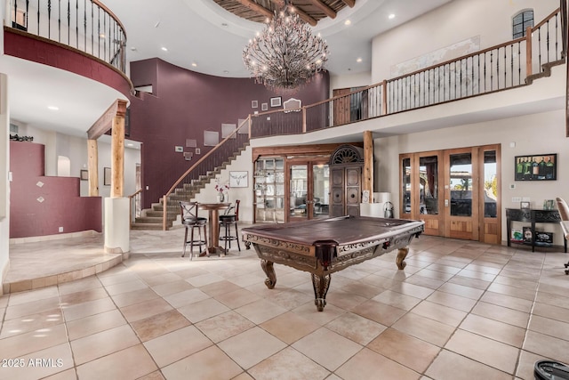 recreation room featuring french doors, a towering ceiling, light tile patterned floors, and pool table