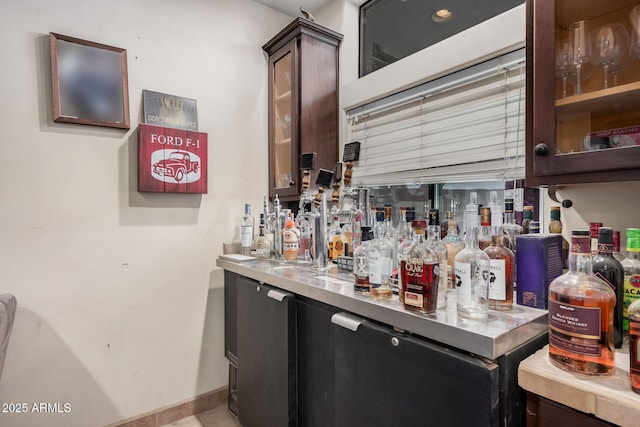 bar featuring dark brown cabinetry