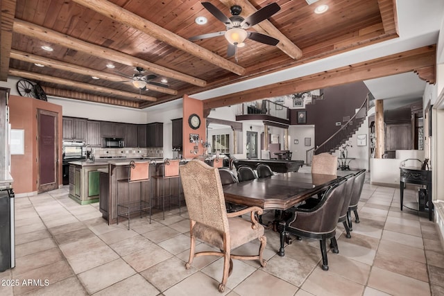 dining area featuring beam ceiling, ceiling fan, and wooden ceiling