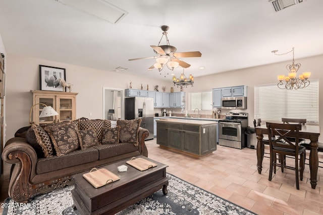 living room featuring ceiling fan with notable chandelier