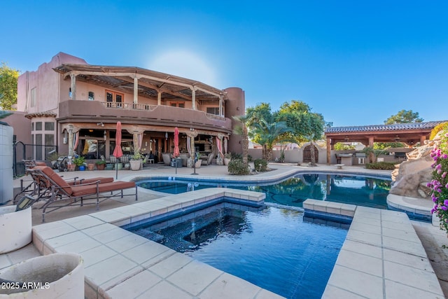 view of pool featuring an in ground hot tub and a patio